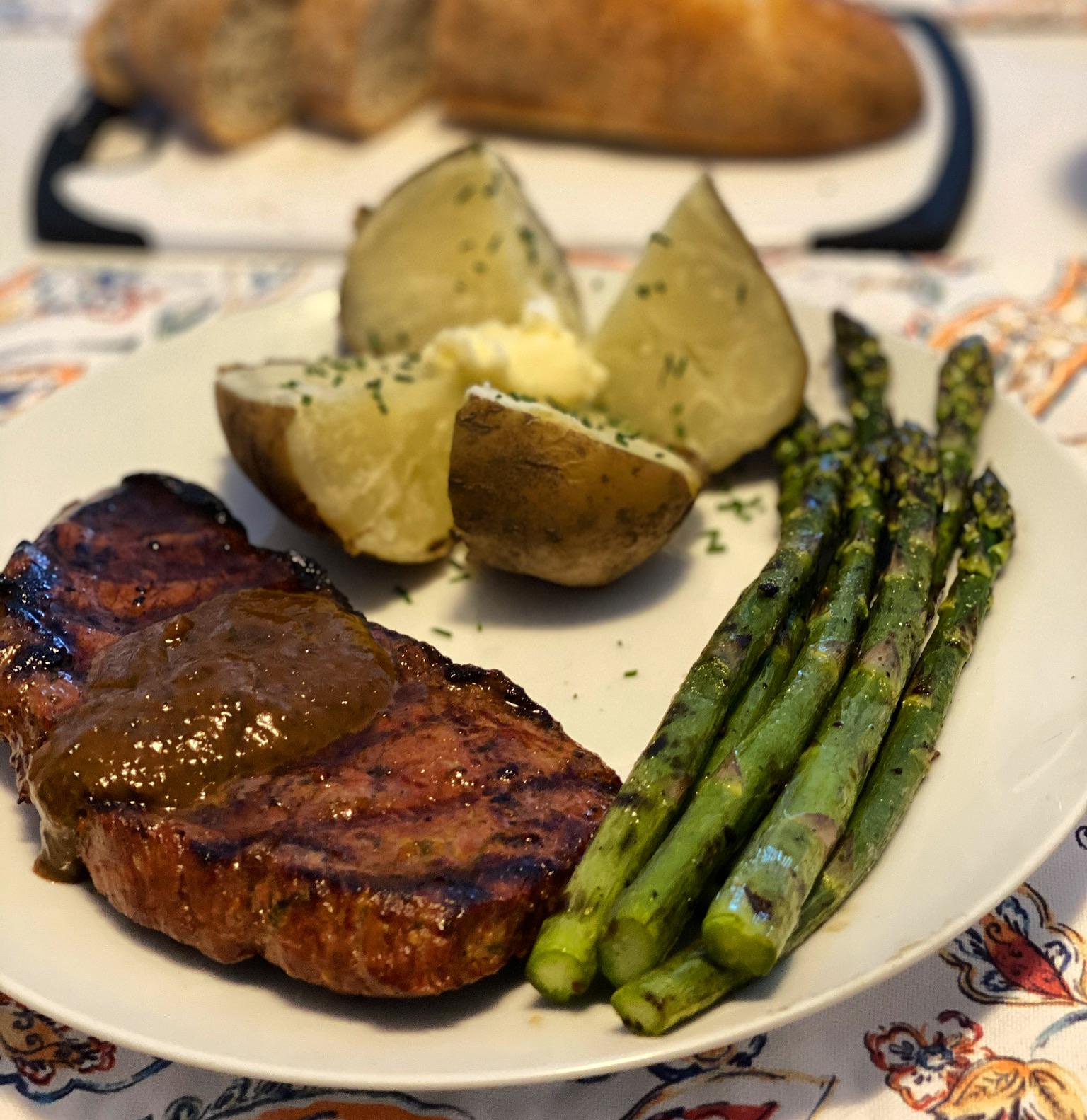 Baked potato, steak, and asparagus