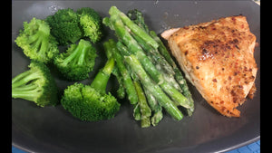 Baked salmon, steamed broccoli, and asparagus with a garlic cream sauce.